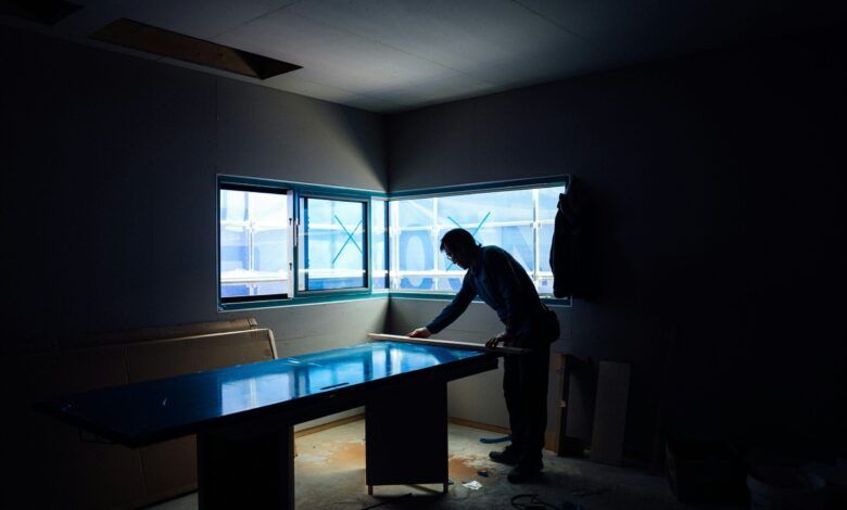 silhouette photography of man inside dim-lighted room