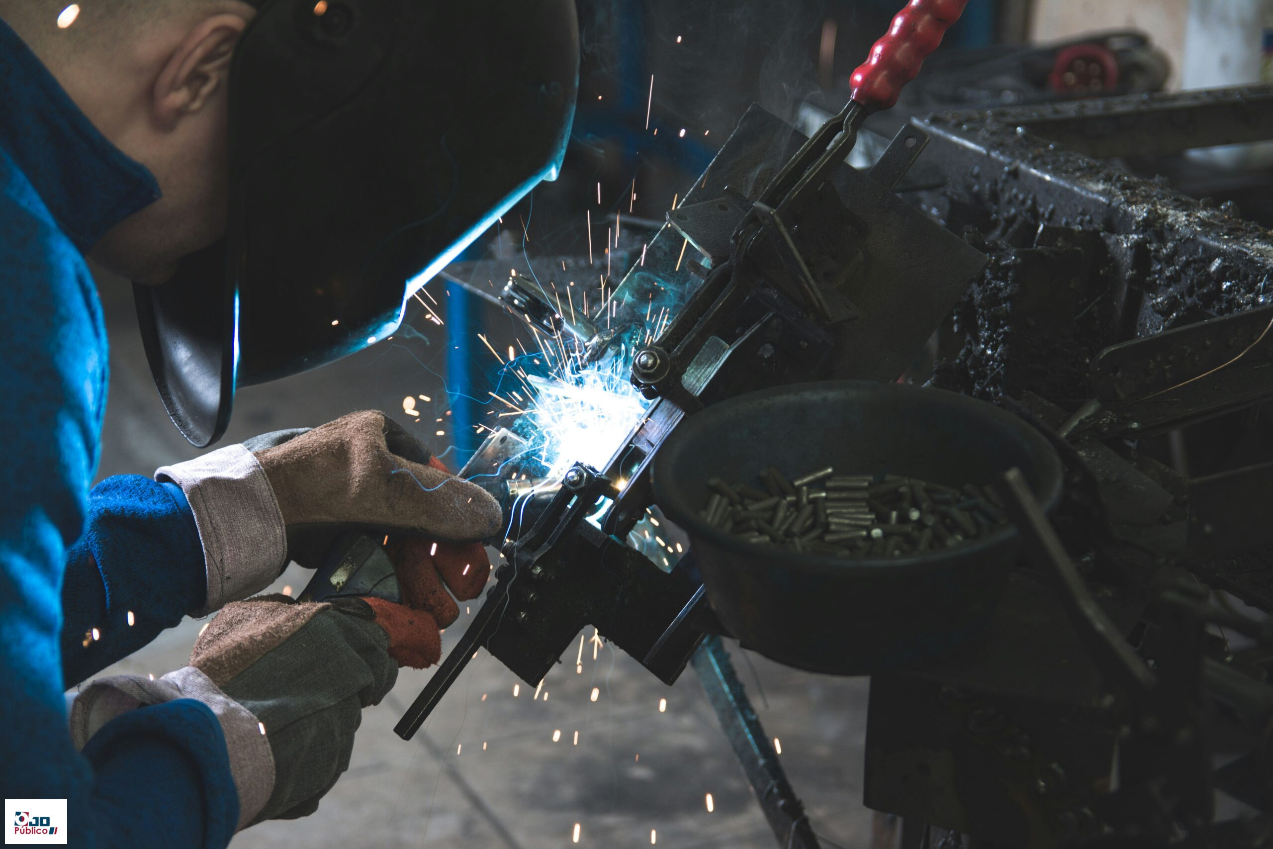 man welding a black metal